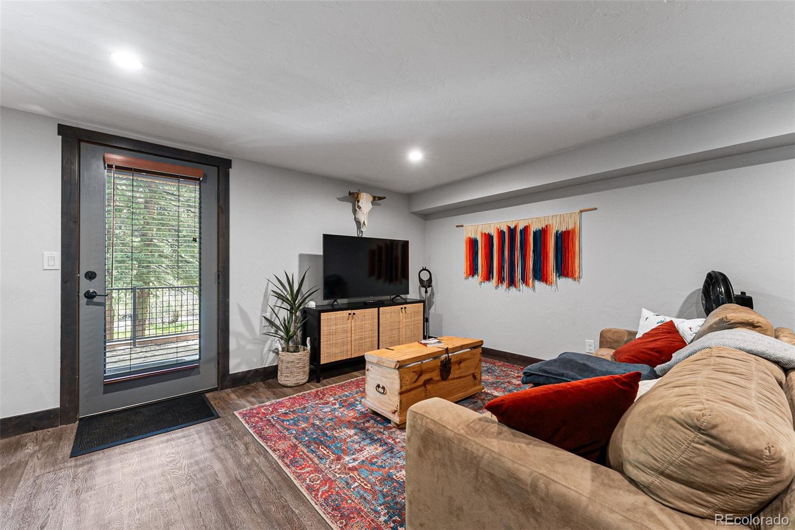 500 Vasquez Road, Unit 7A Winter Park, CO 80482 - Photo 39 of 49 a living room with furniture and a flat screen tv