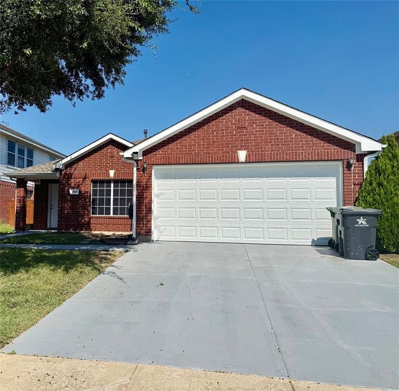 805 Gillon Drive Arlington, TX 76001 - Photo 1 of 12 a front view of a house with a yard and garage