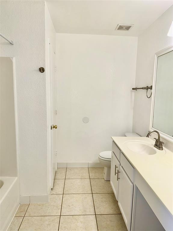 805 Gillon Drive Arlington, TX 76001 - Photo 5 of 12 a bathroom with a sink a toilet and a mirror