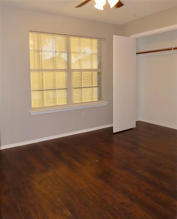 805 Gillon Drive Arlington, TX 76001 - Photo 6 of 12 a view of an empty room with wooden floor and a window