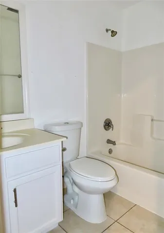a bathroom with a toilet a sink and shower