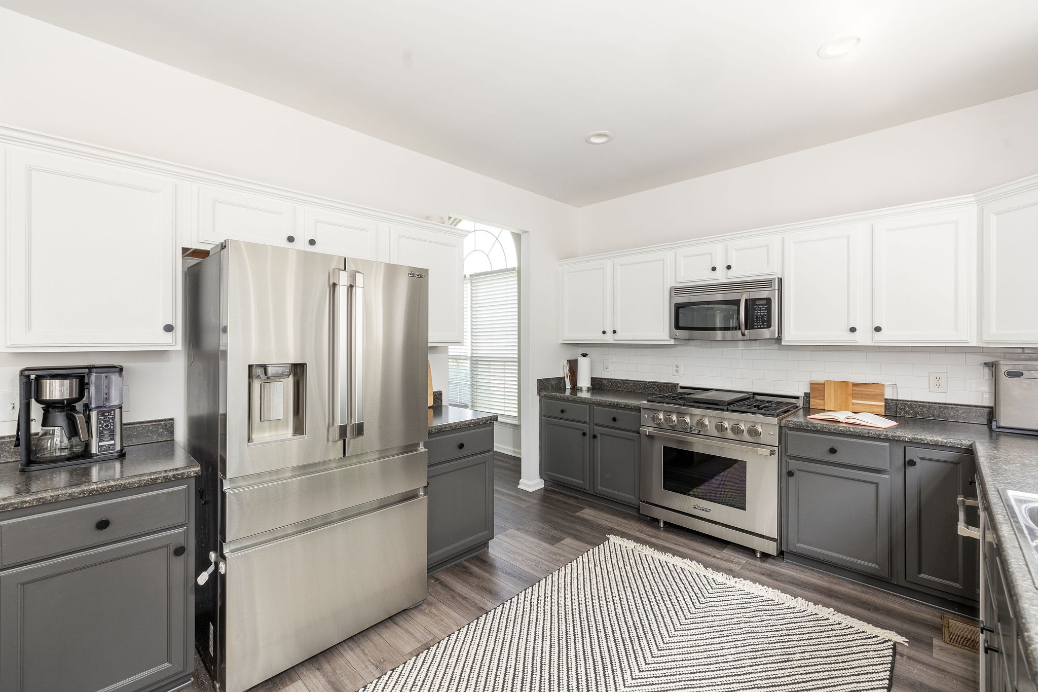 310 Devonshire Drive Franklin, TN 37064 - Photo 11 of 47 a kitchen with stainless steel appliances granite countertop a stove a sink and a refrigerator