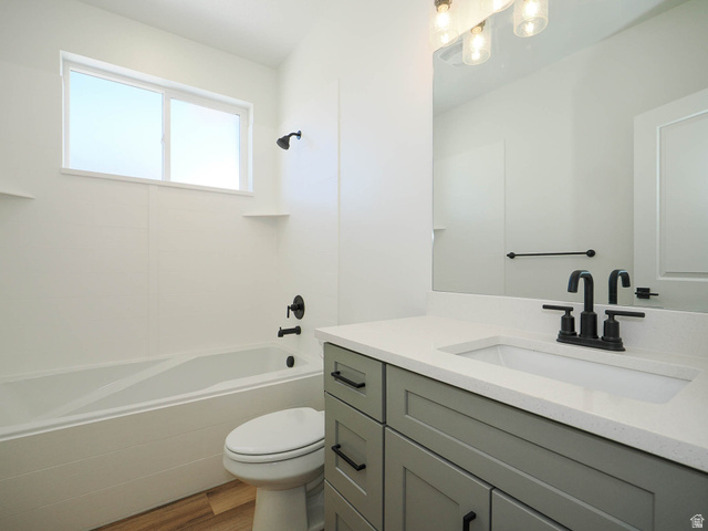 3938 North Wood Road Eagle Mountain, UT 84005 - Photo 26 of 55 Full bath with vanity, light wood finished floors, and shower / washtub combination