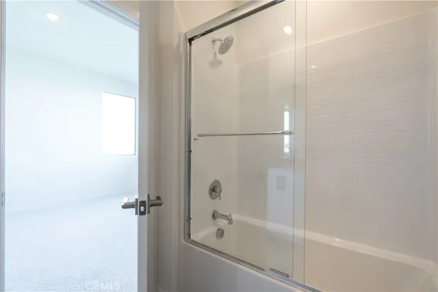a living room with furniture and kitchen