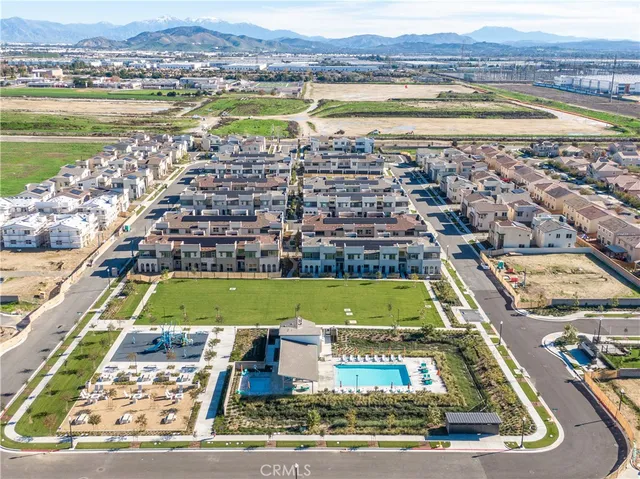an aerial view of a residential apartment building with a yard