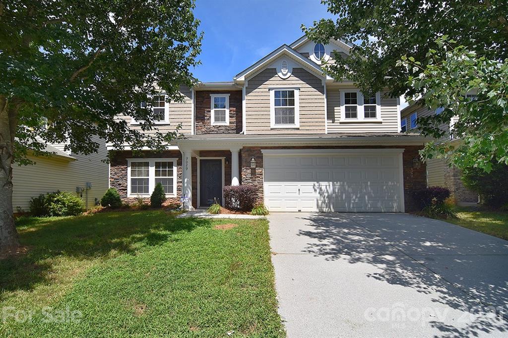 9029 Seamill Road Charlotte, NC 28278 - Photo 1 of 46 a front view of a house with a garden and yard