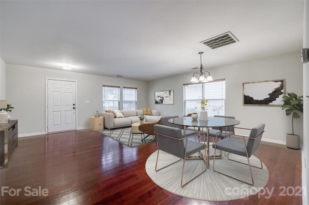 9029 Seamill Road Charlotte, NC 28278 - Photo 2 of 46 a living room with couches chairs and kitchen view with wooden floor