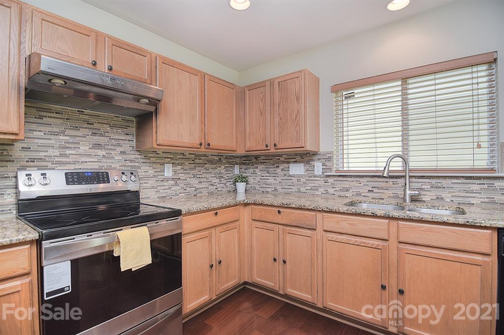 9029 Seamill Road Charlotte, NC 28278 - Photo 11 of 46 a kitchen with granite countertop cabinets stainless steel appliances and a sink