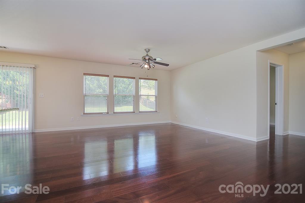 9029 Seamill Road Charlotte, NC 28278 - Photo 13 of 46 an empty room with wooden floor and windows