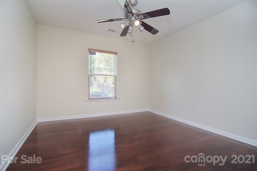 9029 Seamill Road Charlotte, NC 28278 - Photo 16 of 46 an empty room with a window and a ceiling fan