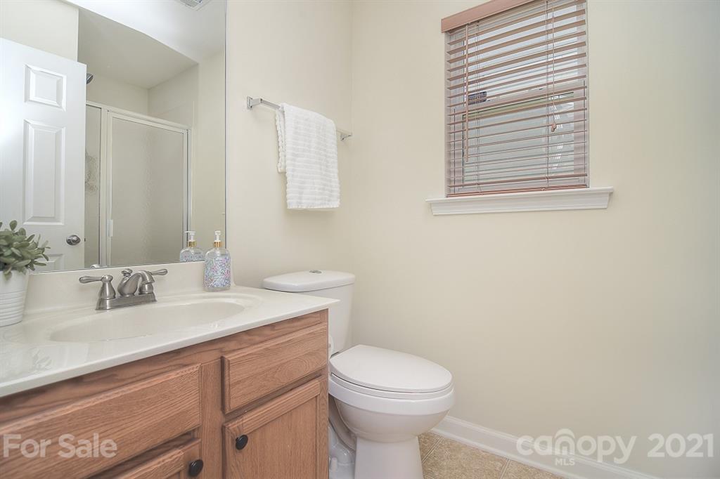 9029 Seamill Road Charlotte, NC 28278 - Photo 17 of 46 a bathroom with a sink a toilet and mirror