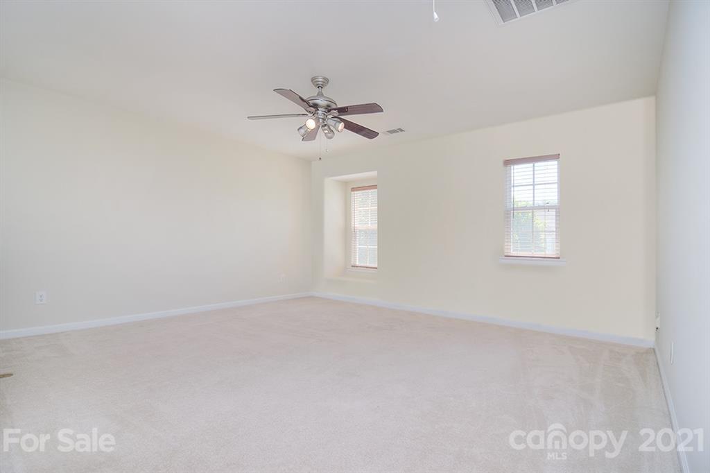 9029 Seamill Road Charlotte, NC 28278 - Photo 20 of 46 an empty room with windows and fan