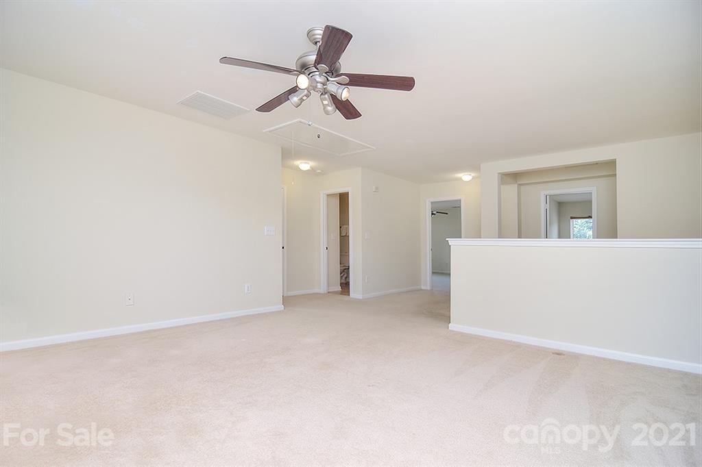 9029 Seamill Road Charlotte, NC 28278 - Photo 21 of 46 a view of a livingroom with a ceiling fan and kitchen view