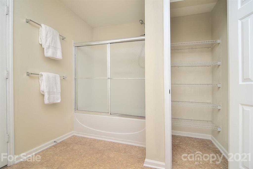 9029 Seamill Road Charlotte, NC 28278 - Photo 25 of 46 a bathroom with a bathtub and shower