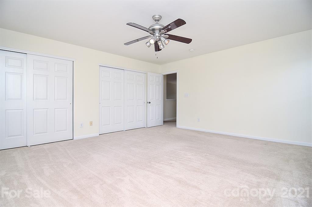9029 Seamill Road Charlotte, NC 28278 - Photo 29 of 46 an empty room with closet and ceiling fan