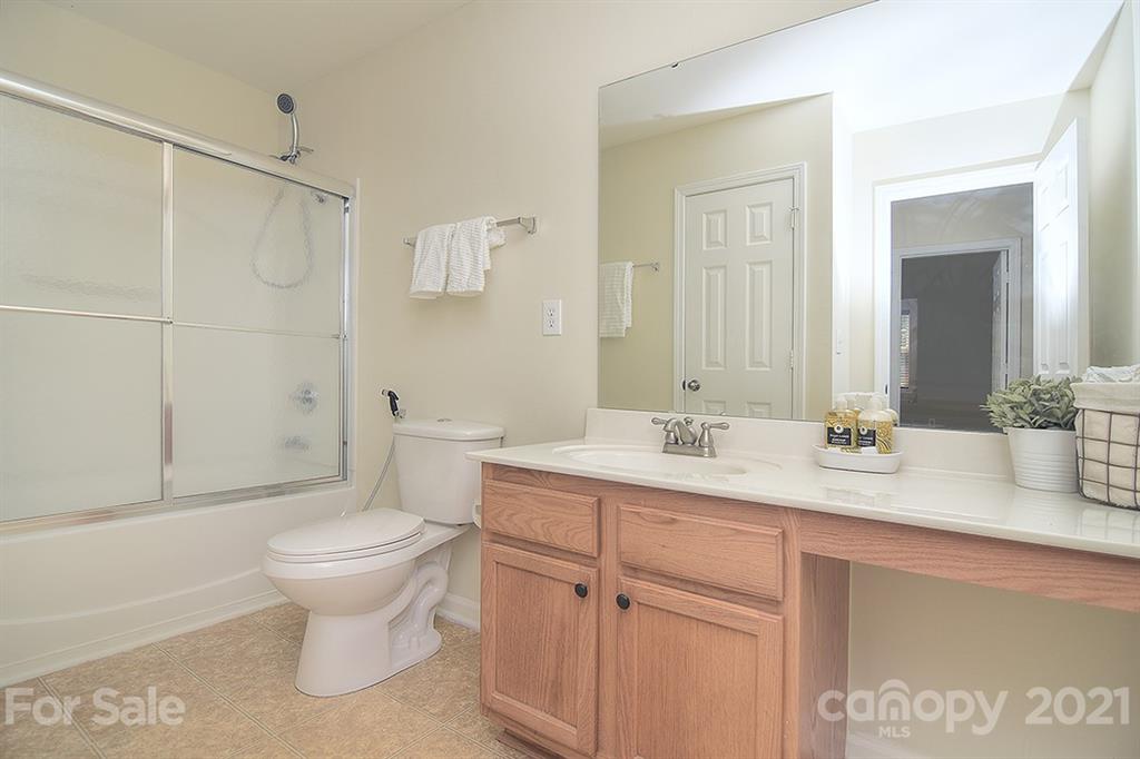 9029 Seamill Road Charlotte, NC 28278 - Photo 30 of 46 a bathroom with a sink toilet and shower