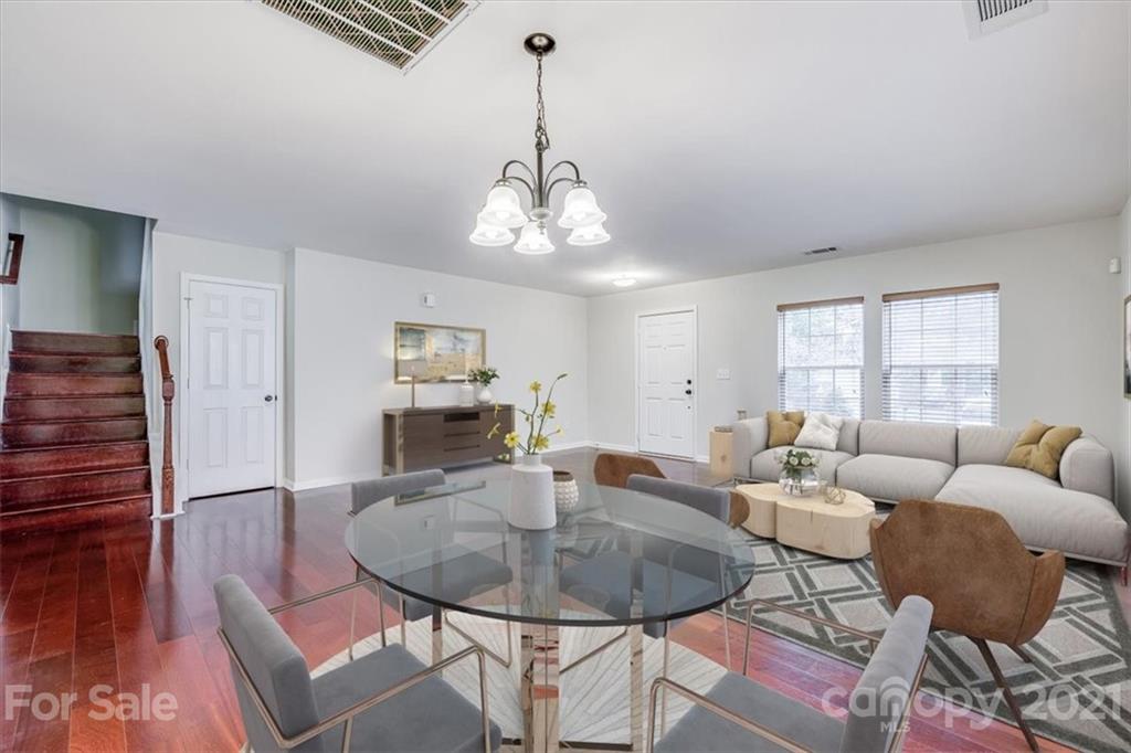 9029 Seamill Road Charlotte, NC 28278 - Photo 4 of 46 a living room with furniture a dining table and a chandelier