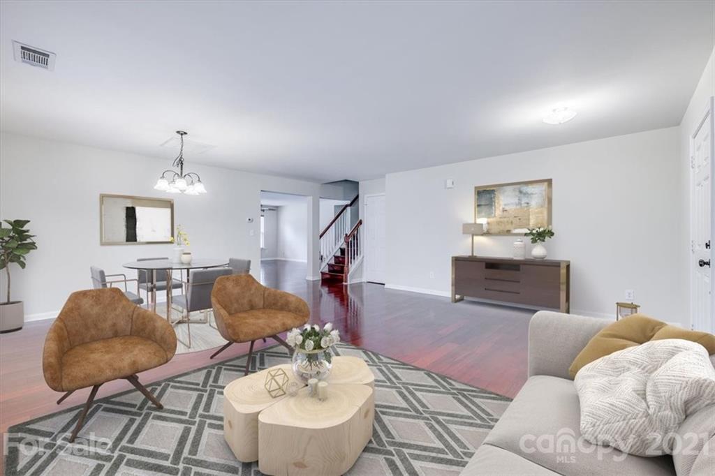 9029 Seamill Road Charlotte, NC 28278 - Photo 6 of 46 a living room with furniture and a chandelier