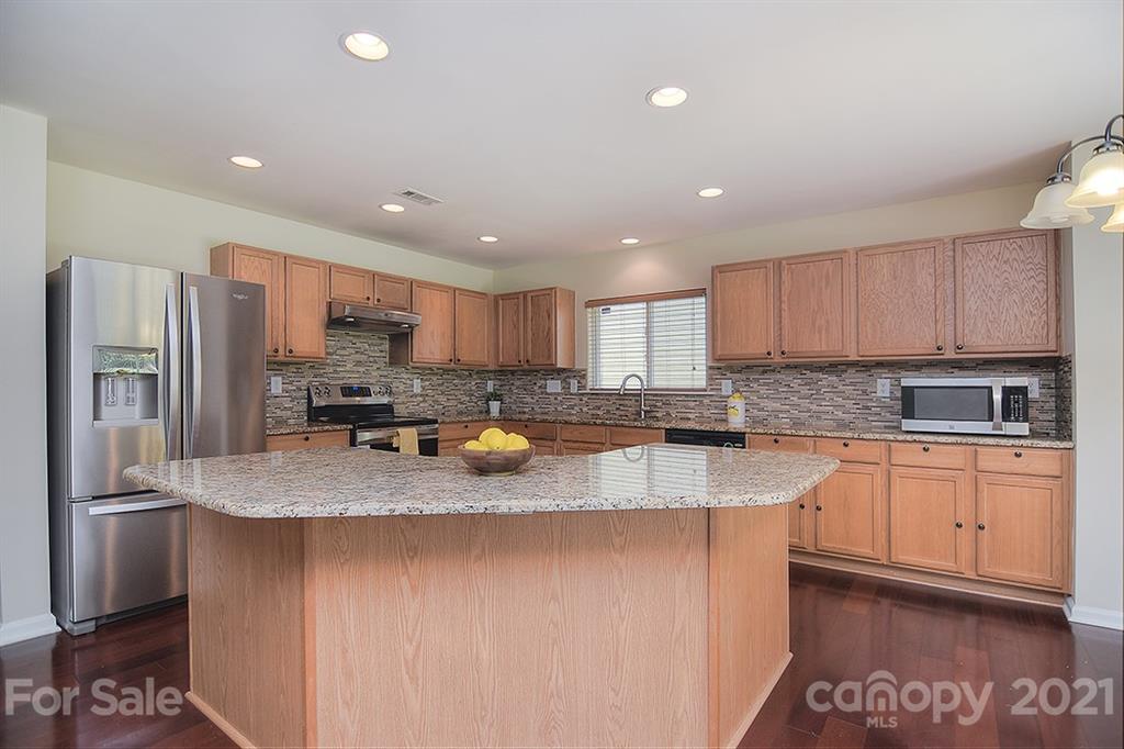 9029 Seamill Road Charlotte, NC 28278 - Photo 8 of 46 a kitchen with stainless steel appliances granite countertop a sink refrigerator and cabinets