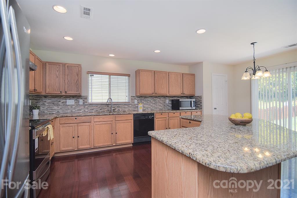 9029 Seamill Road Charlotte, NC 28278 - Photo 9 of 46 a kitchen with stainless steel appliances granite countertop a sink a stove a microwave and island