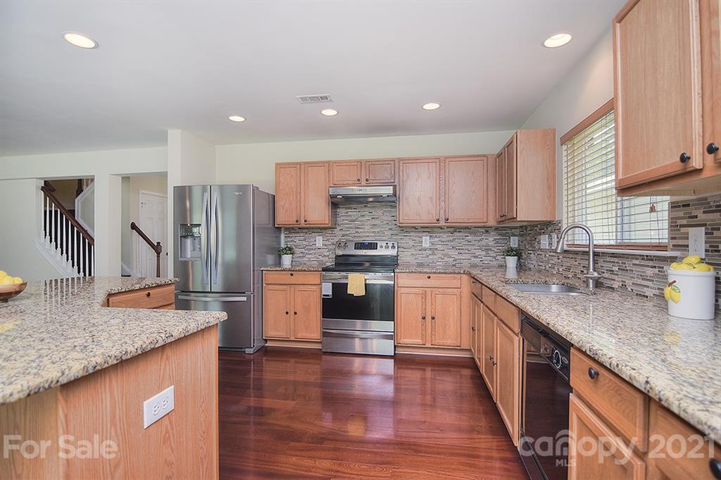 9029 Seamill Road Charlotte, NC 28278 - Photo 10 of 46 a kitchen with stainless steel appliances granite countertop a sink stove and refrigerator