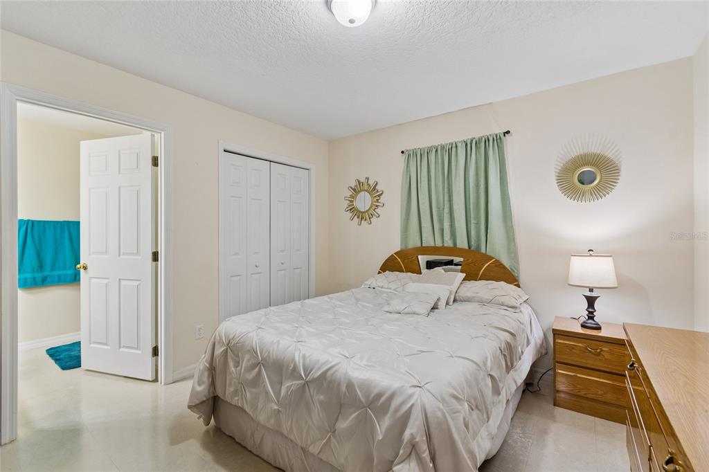 468 North Wheeler Avenue Inverness, FL 34453 - Photo 16 of 24 a bedroom with a bed and a chandelier
