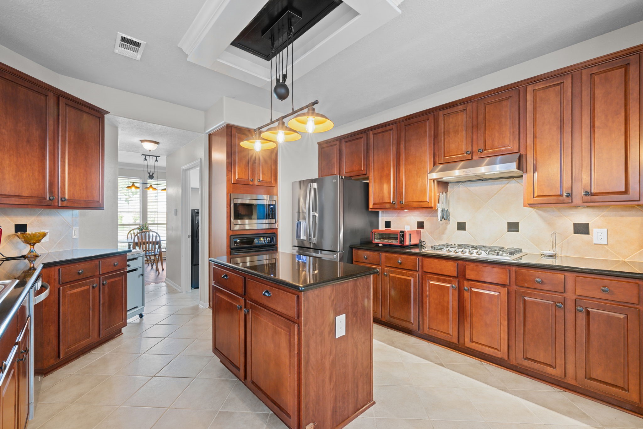 19114 Emory Trail Spring, TX 77388 - Photo 15 of 44 a kitchen with stainless steel appliances granite countertop wooden cabinets a sink a stove and a refrigerator