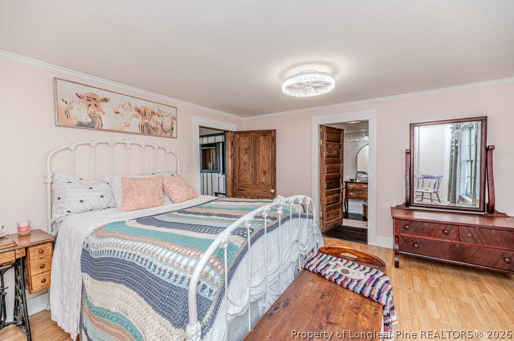 509 Carthage Street Cameron, NC 28326 - Photo 14 of 43 a bedroom with a bed and a couch