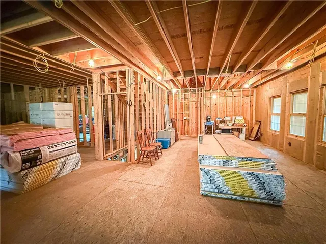 a backyard of a house with barbeque oven table and chairs