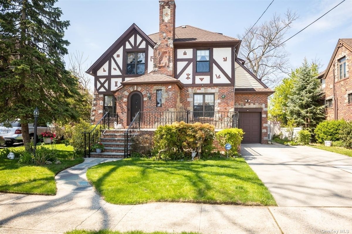 64 Reyam Road Lynbrook, NY 11563 - Photo 1 of 1 a front view of a house with a garden