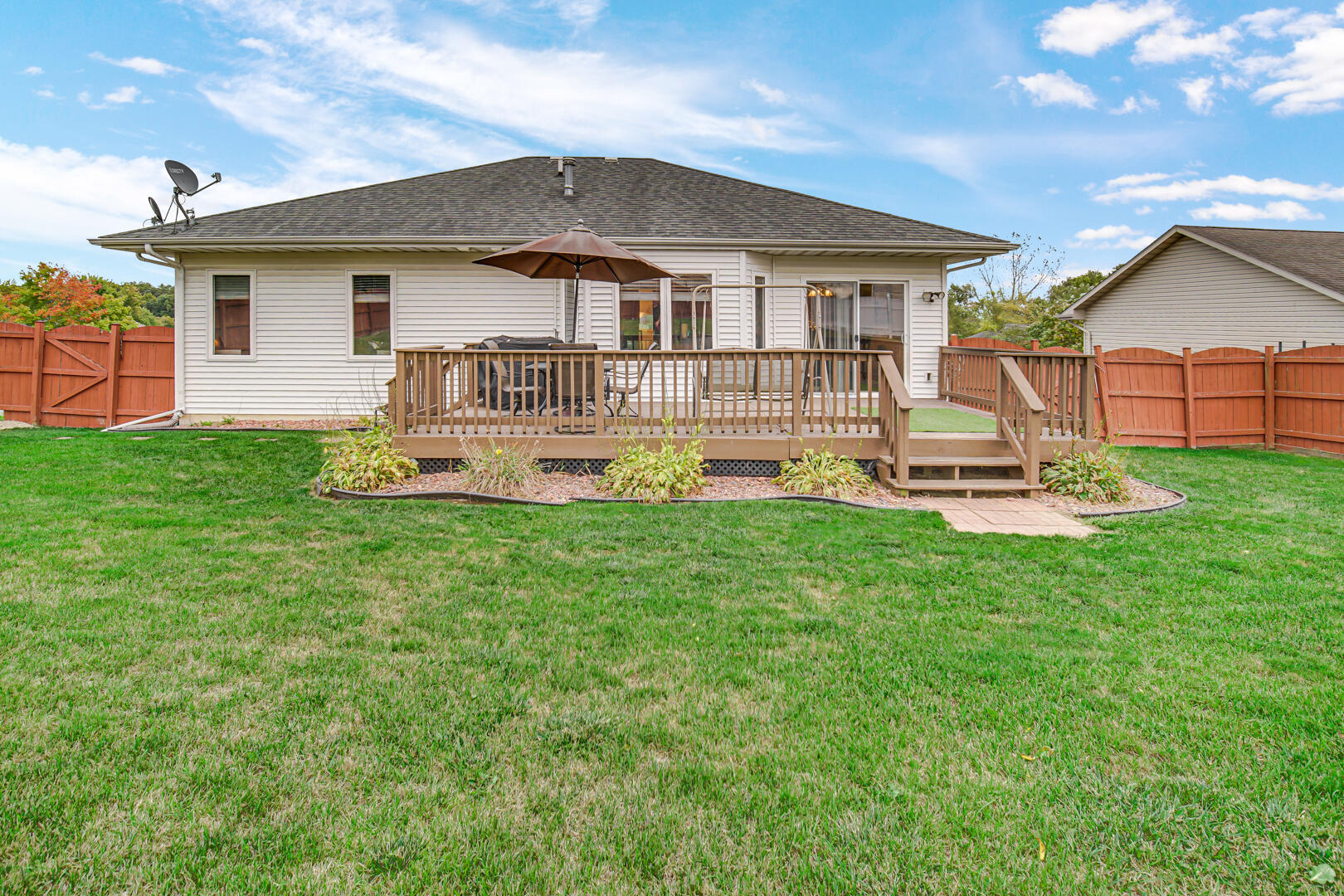 1055 Doe Path Lane Crown Point, IN 46307 - Photo 14 of 26 a front view of a house with a yard table and chairs