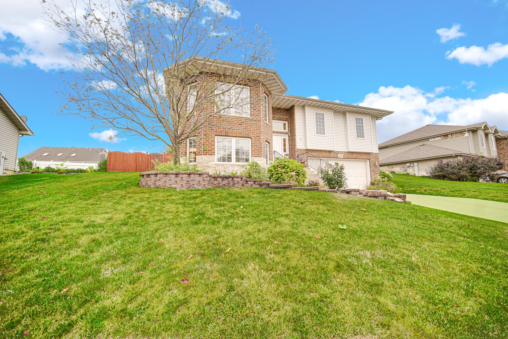 1055 Doe Path Lane Crown Point, IN 46307 - Photo 2 of 26 a front view of a house with garden
