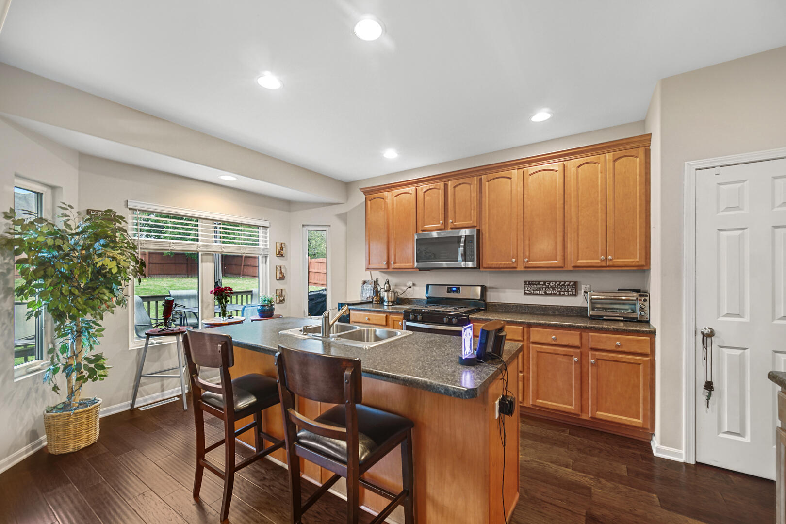 1055 Doe Path Lane Crown Point, IN 46307 - Photo 4 of 26 a open dining room with stainless steel appliances a dining table and chairs