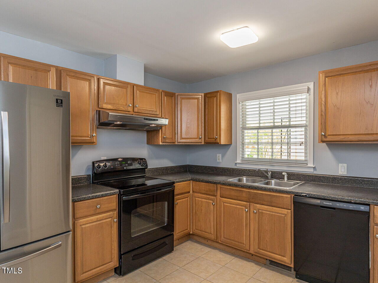 4607 Blanchard Road Durham, NC 27713 - Photo 12 of 31 a kitchen with granite countertop a sink stove and refrigerator