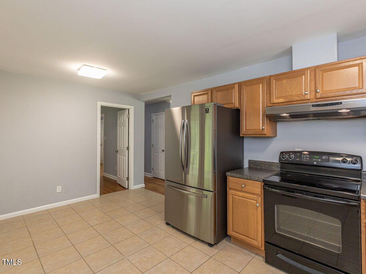 4607 Blanchard Road Durham, NC 27713 - Photo 13 of 31 a kitchen with a refrigerator stove and cabinets