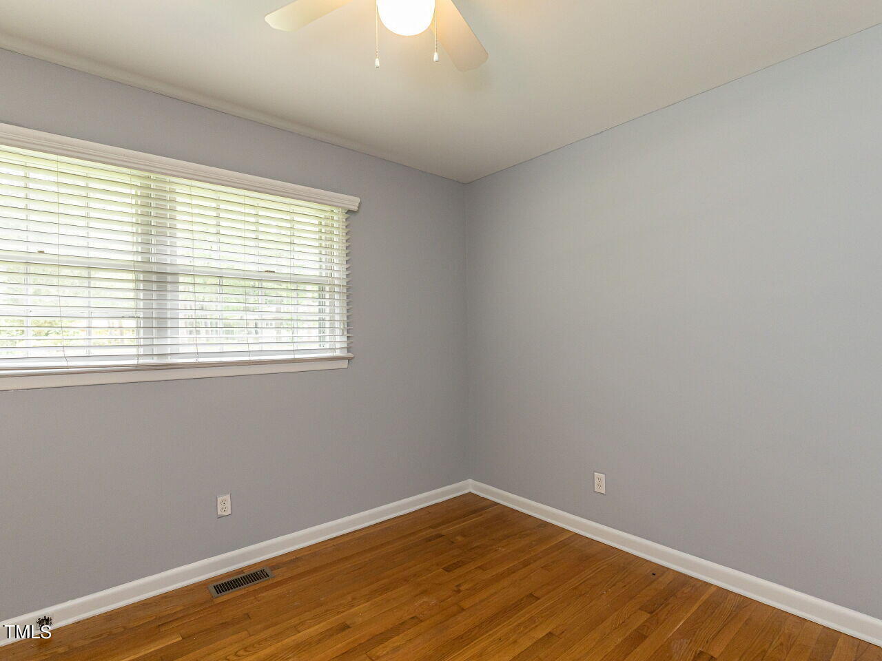 4607 Blanchard Road Durham, NC 27713 - Photo 16 of 31 a view of an empty room with wooden floor and a window