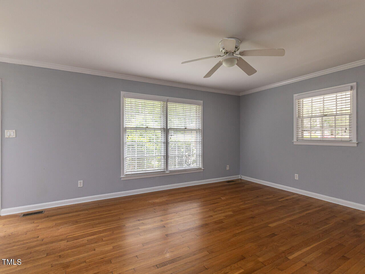 4607 Blanchard Road Durham, NC 27713 - Photo 6 of 31 a view of an empty room with wooden floor and a window