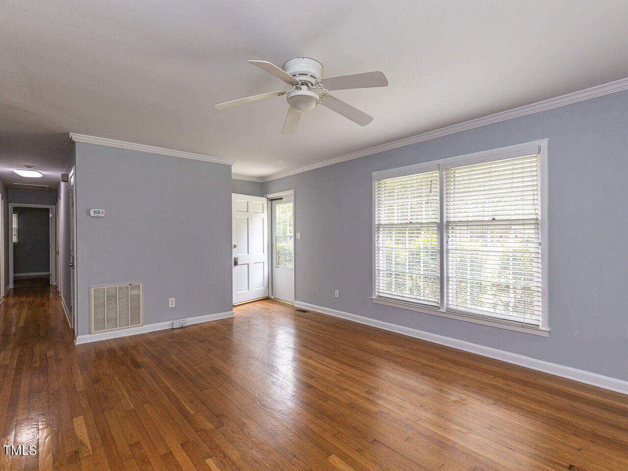 4607 Blanchard Road Durham, NC 27713 - Photo 7 of 31 a view of an empty room with wooden floor and a window