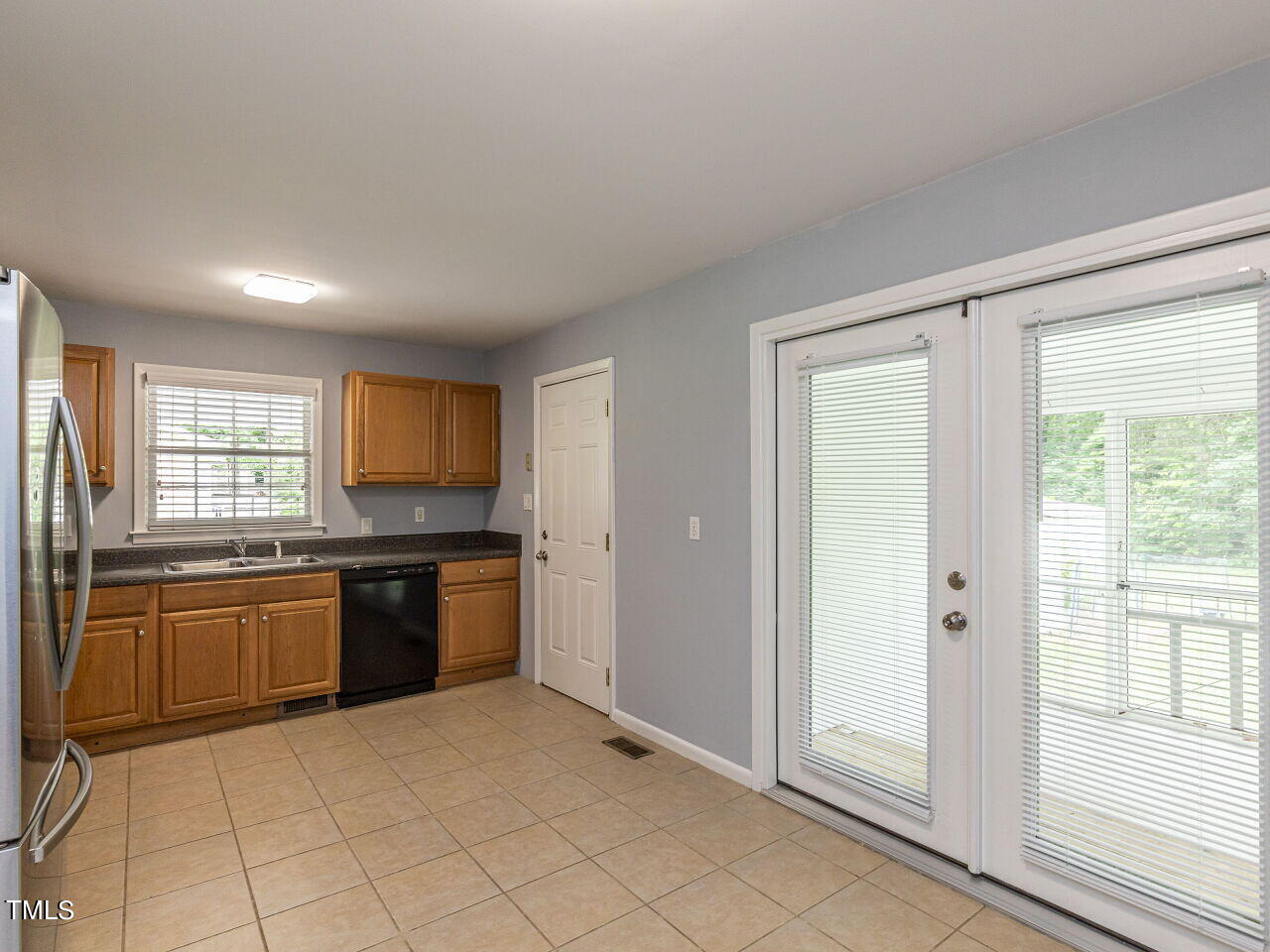 4607 Blanchard Road Durham, NC 27713 - Photo 9 of 31 a large kitchen with stainless steel appliances granite countertop a stove top oven a sink and a refrigerator