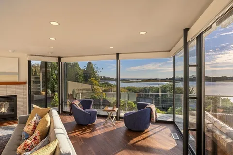 a living room with furniture and a floor to ceiling window