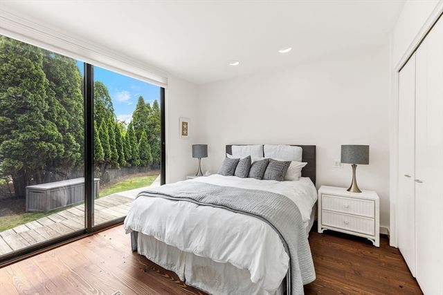 a bed room with a bed and a large window