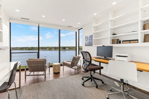 a workspace with furniture and a floor to ceiling window