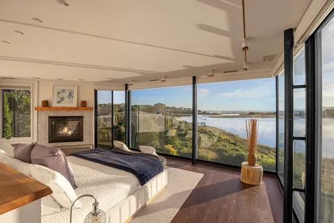 a bedroom with a bed and large window