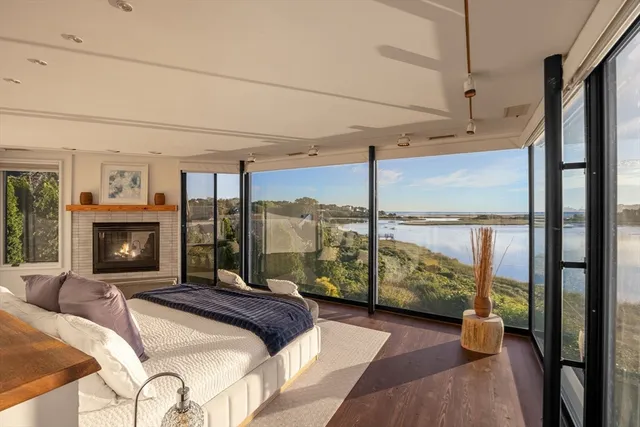 a bedroom with a bed and large window