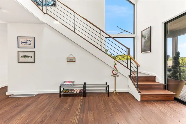 a view of entryway with wooden floor and stairs