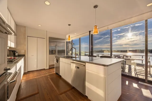 a kitchen with stainless steel appliances granite countertop a sink and stove