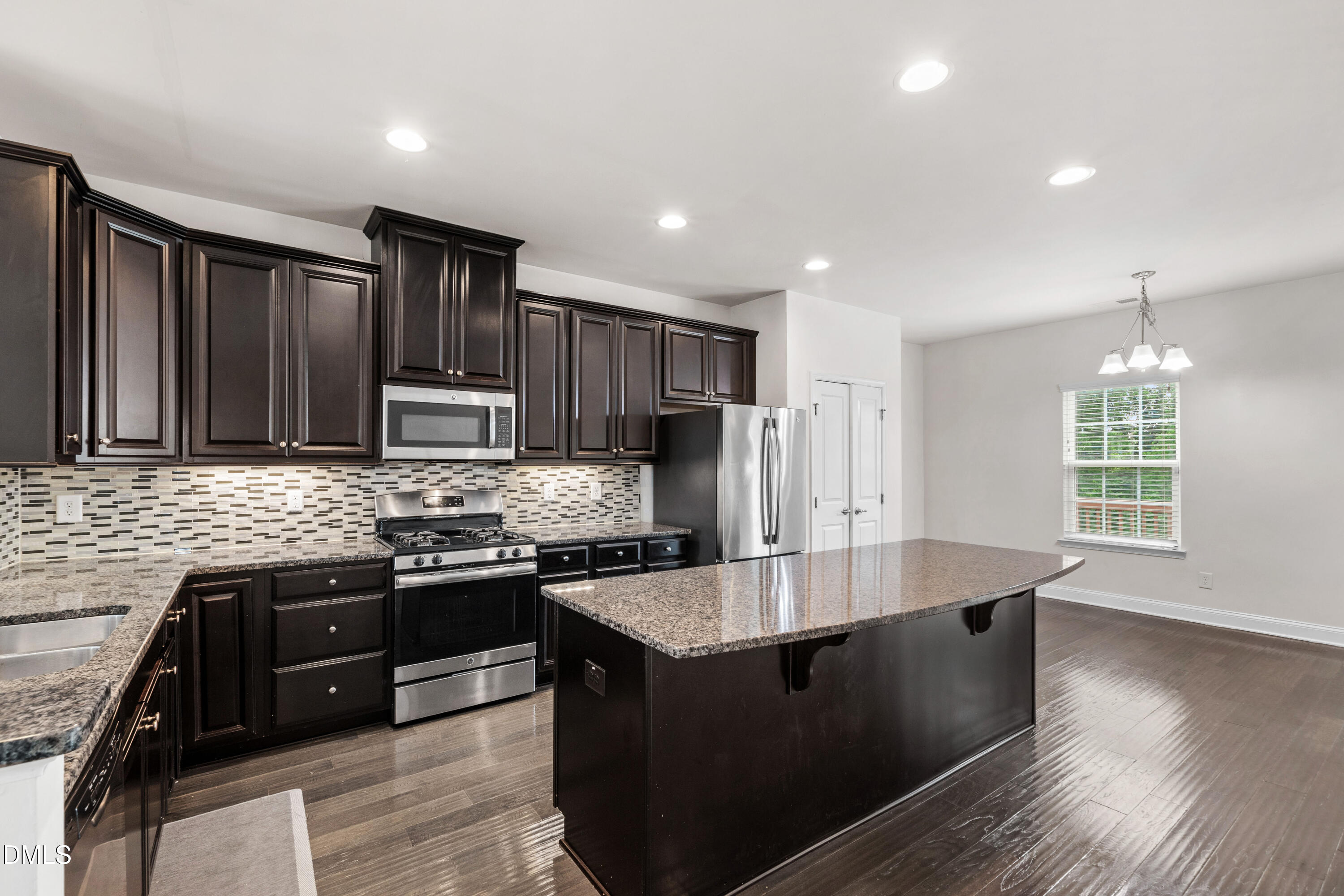 1101 Boxcar Way Apex, NC 27502 - Photo 4 of 27 an open kitchen with granite countertop a stove and a sink
