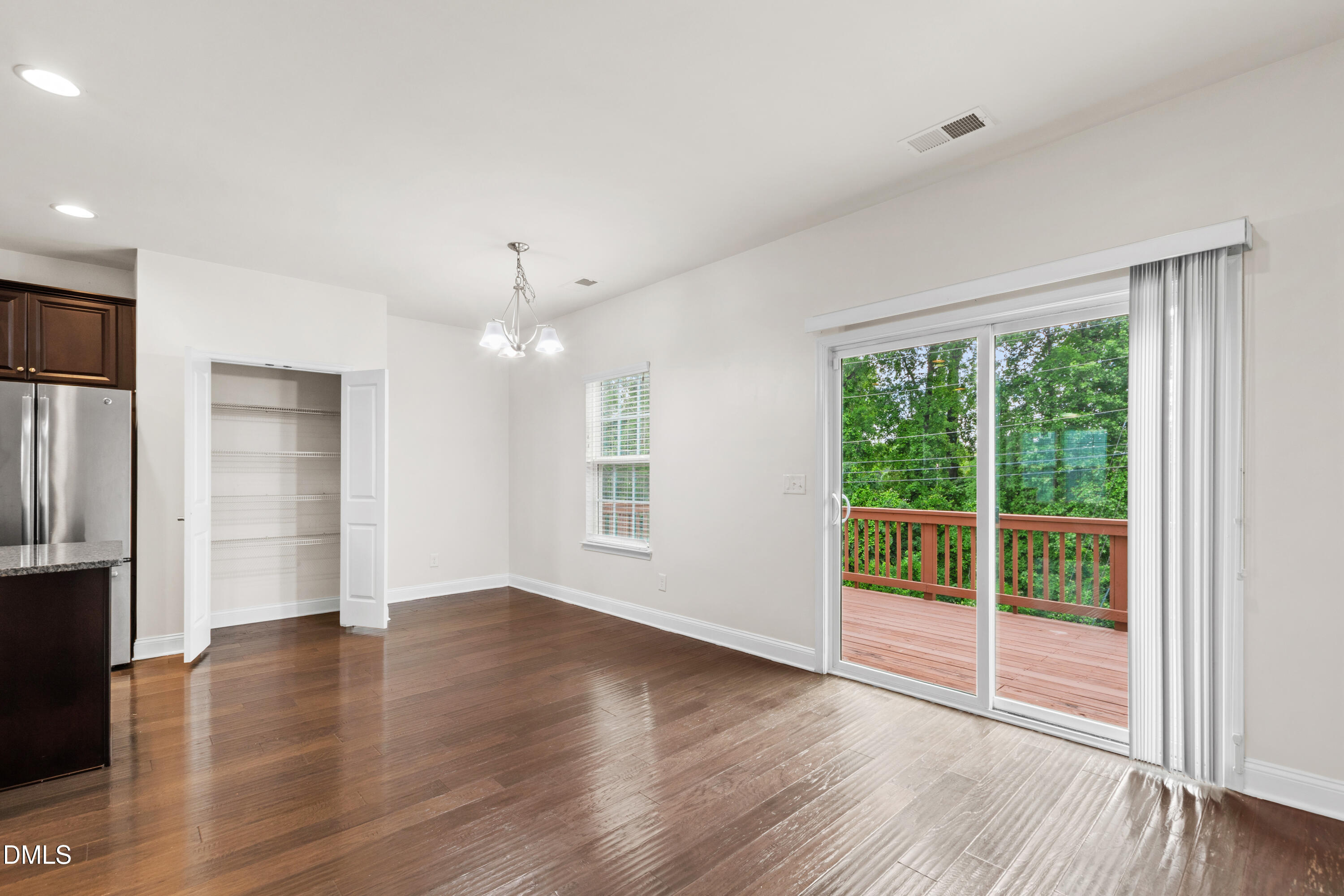 1101 Boxcar Way Apex, NC 27502 - Photo 8 of 27 an empty room with wooden floor and windows