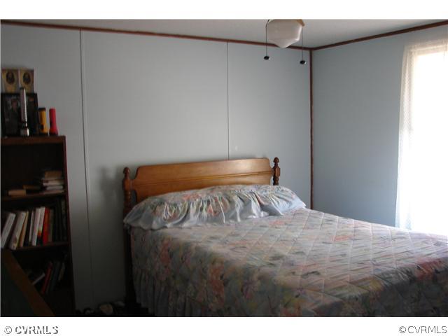 807 Scotts Bottom Road Dillwyn, VA 23936 - Photo 3 of 6 a bedroom with a bed and a book shelf