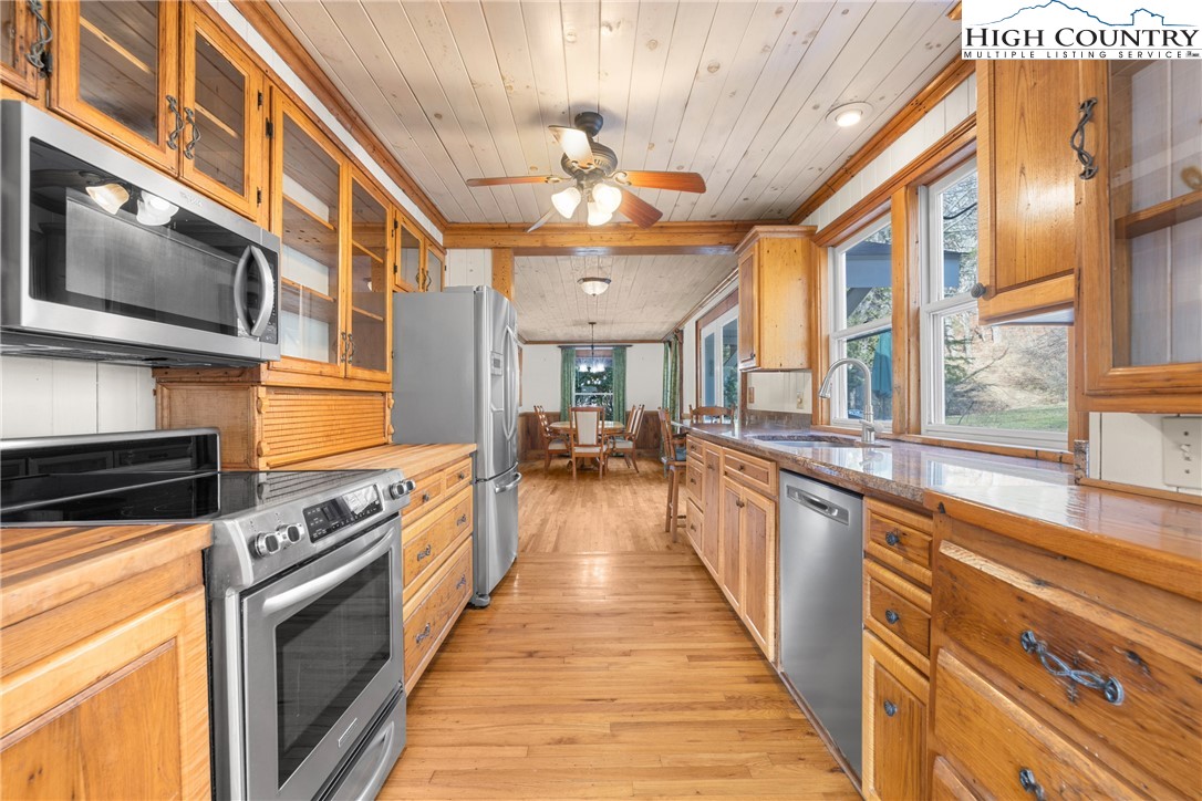 211 Possum Hollow Road Blowing Rock, NC 28605 - Photo 12 of 46 a large kitchen with stainless steel appliances granite countertop lots of counter top space and wooden floor